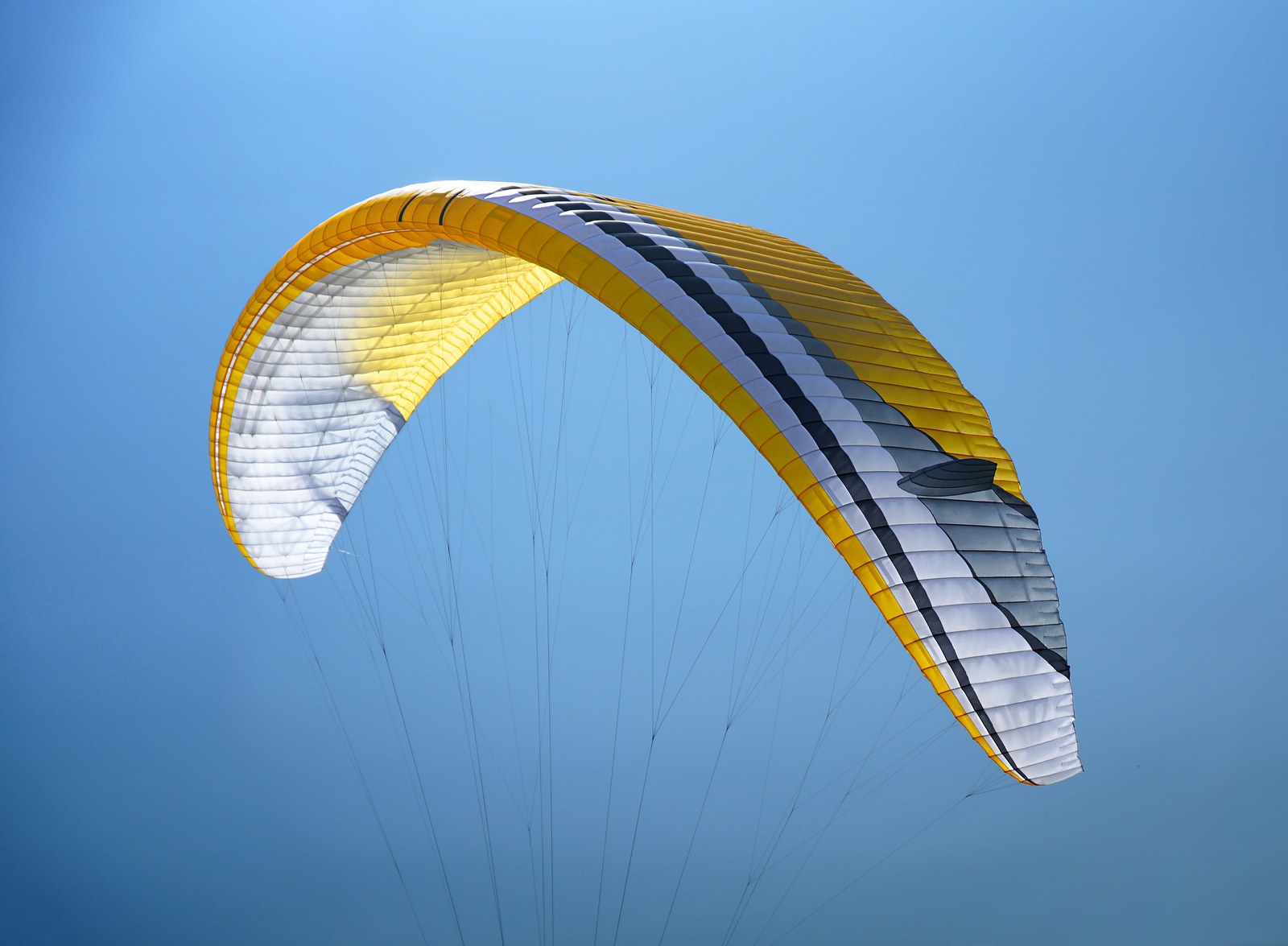 MacPara Verve in the gold colourway — inflated above a blue-sky background